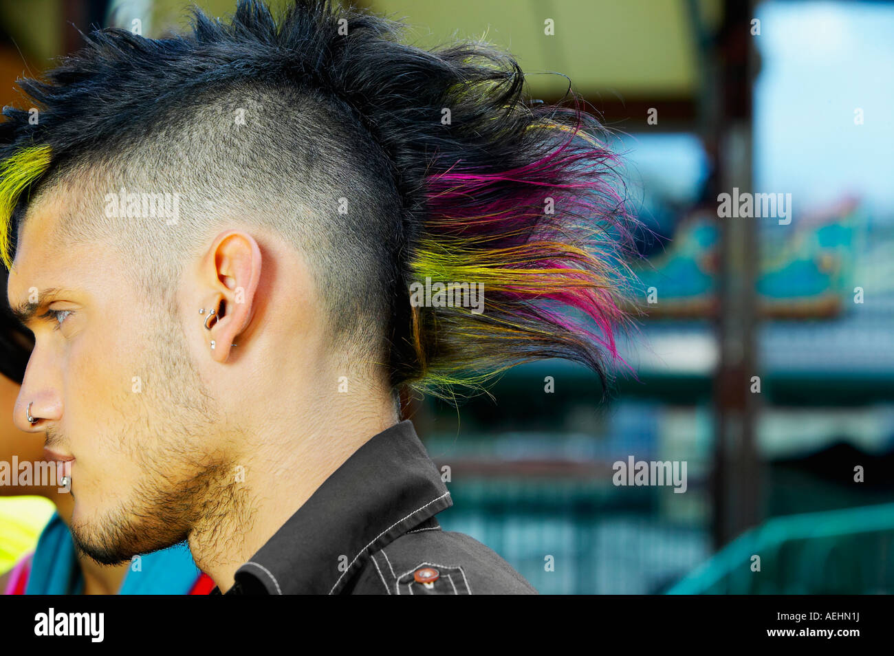 Profile of Hispanic male punk with mohawk hairstyle outdoors Stock Photo