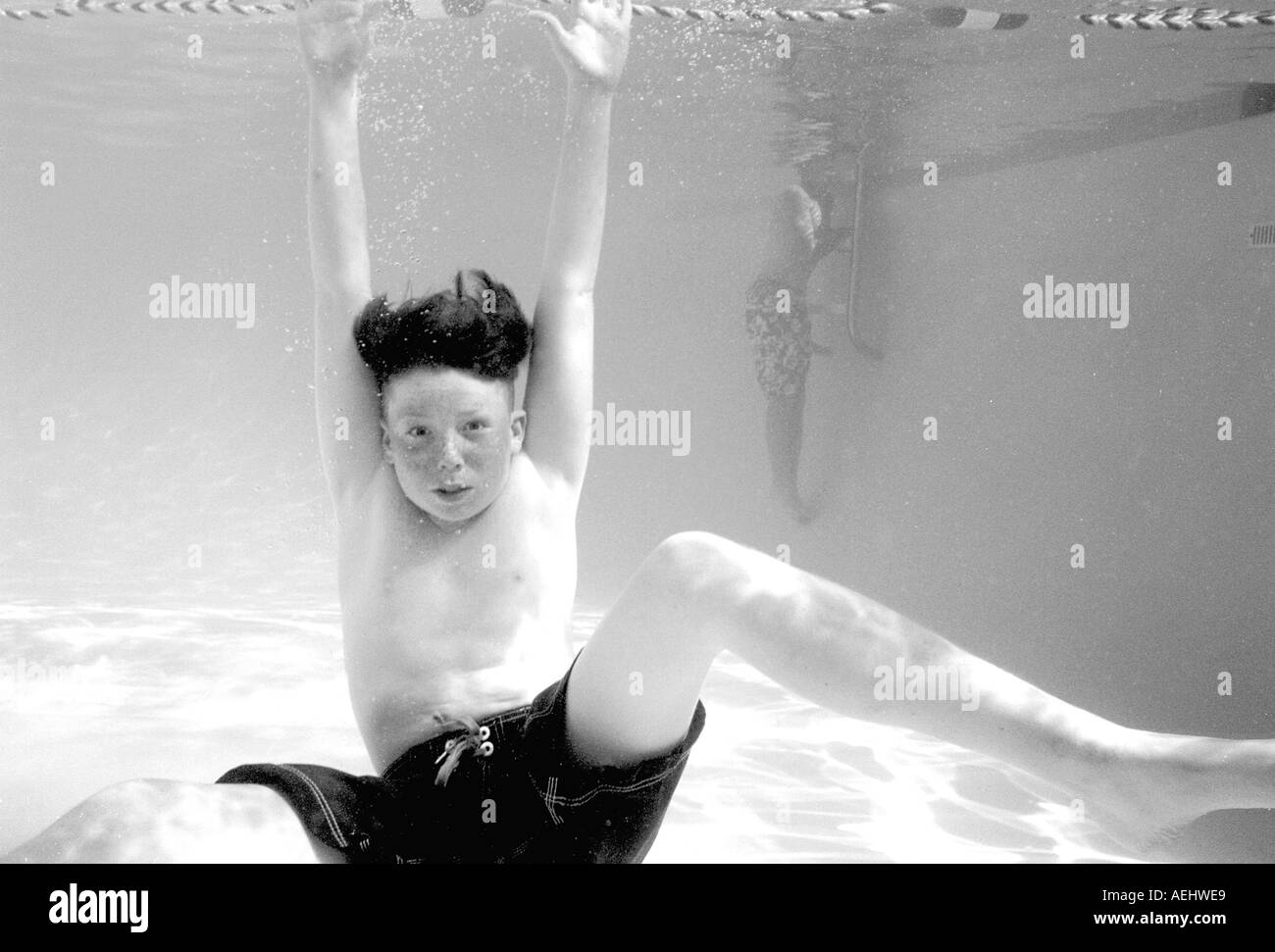 Boy underneath water in swimming pool  Stock Photo