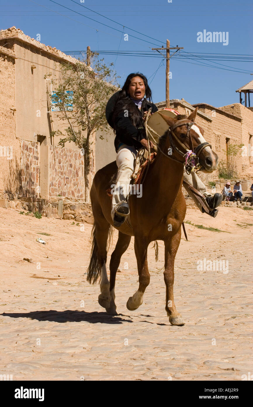 Women's Riding Instrument Indigenous woman riding a horse during carnival in Yavi Provincia de ...