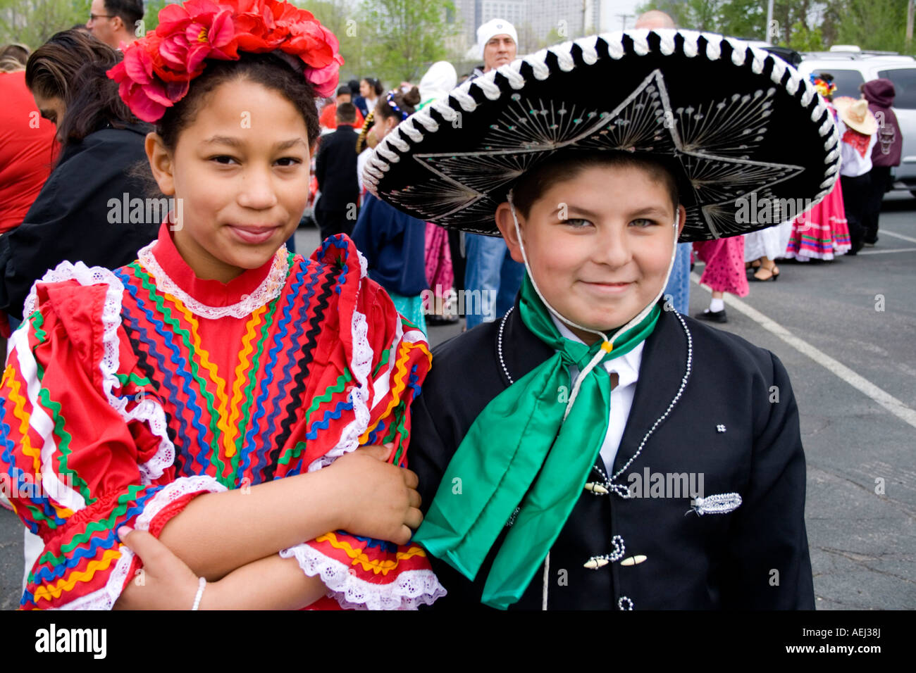 Girl and boy age 10 and 12 wearing sombrero and colorful parade attire ...