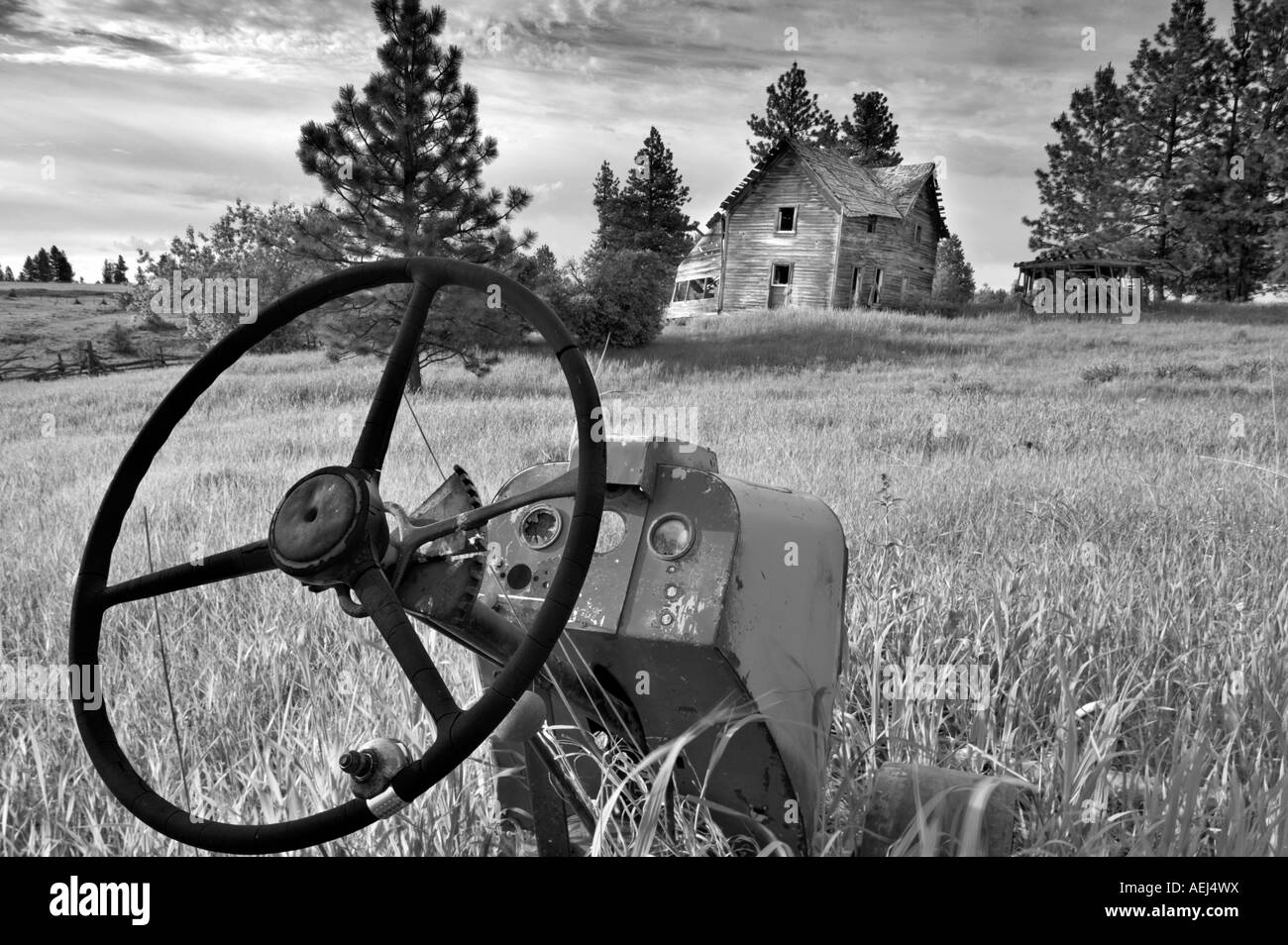Old tractor and abandoned farm home Near Flora Oregon Stock Photo