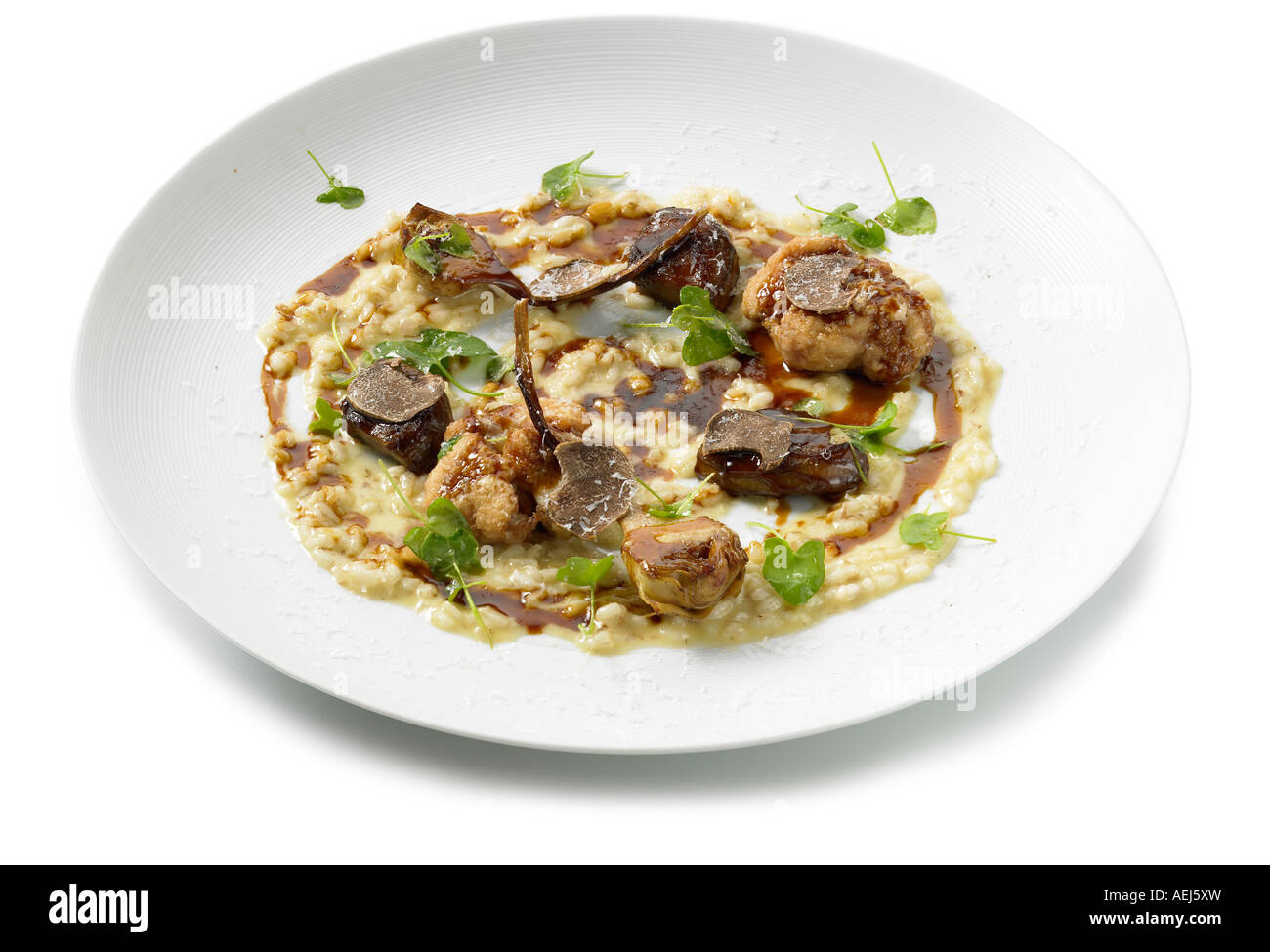 Roasted veal sweetbreads with creamed pearl barley and roasted Jerusalem artichoke Stock Photo