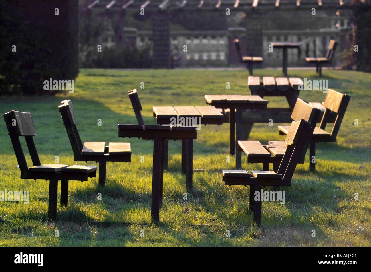 Wooden Park Benches And Tables Set Into Ground On Grass Stock