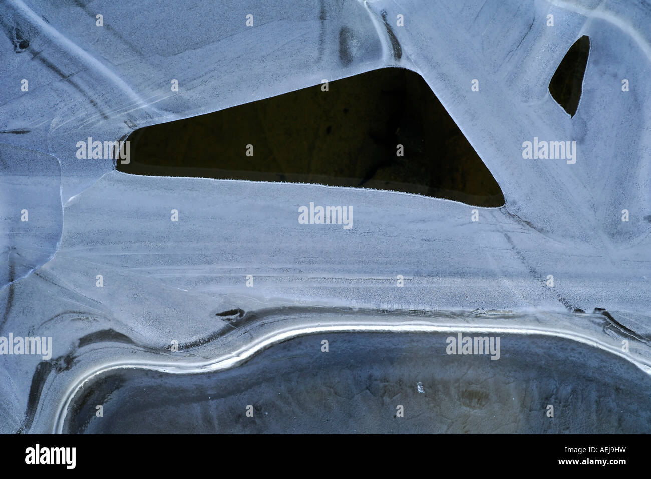 Art in nature, thin ice cap on a puddle Stock Photo