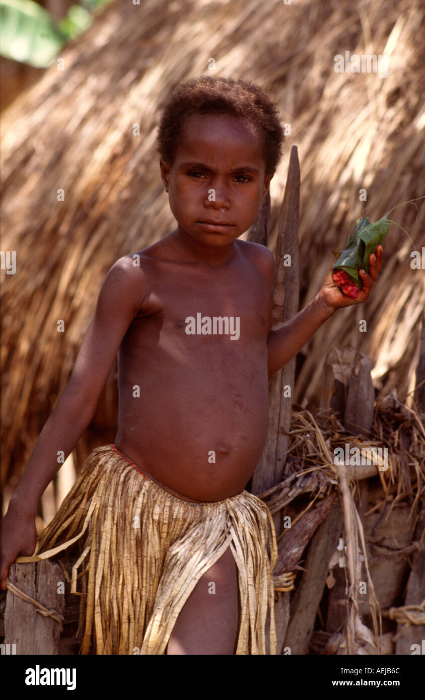 Young Dani girl carrying pig meat wrapped in a leaf Bolokme Baliem Valley Irian Jaya Indonesia Stock Photo