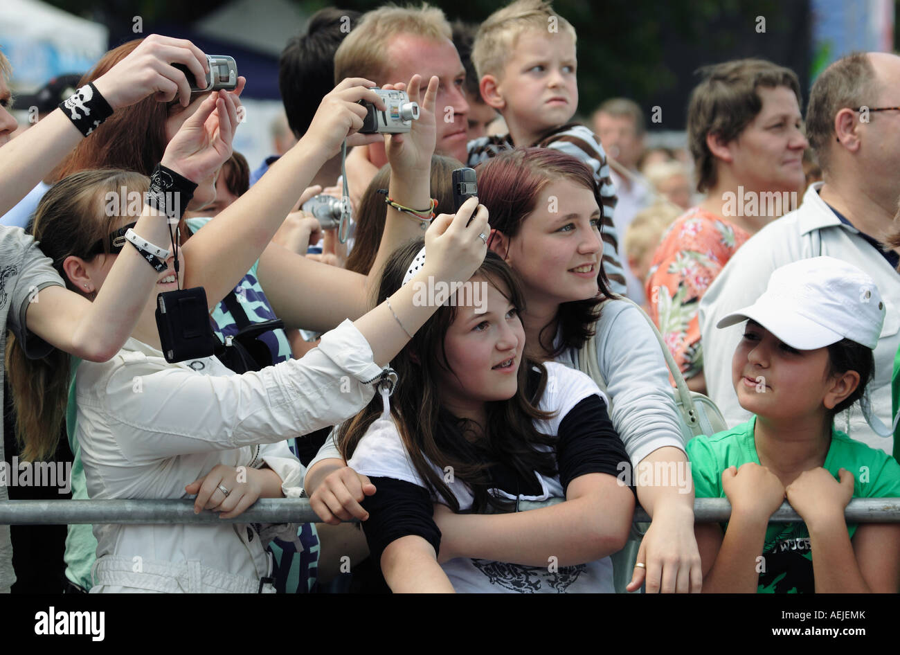 Fans looking curiously and taking pictures Stock Photo