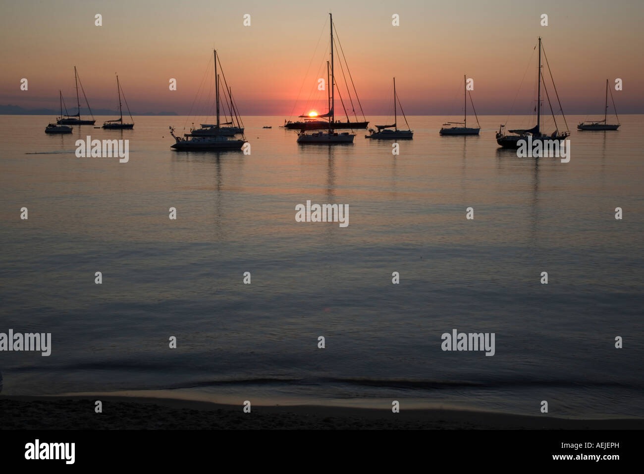 Sunset with sailing boats Stock Photo