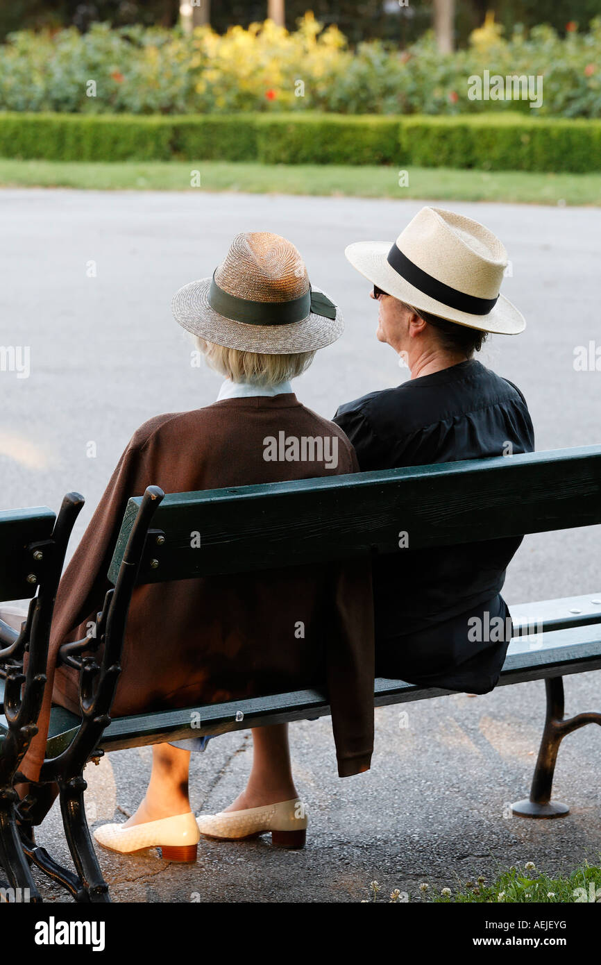 Two female senior citizens sitting on a park bench, Volksgarten, Vienna, Austria Stock Photo