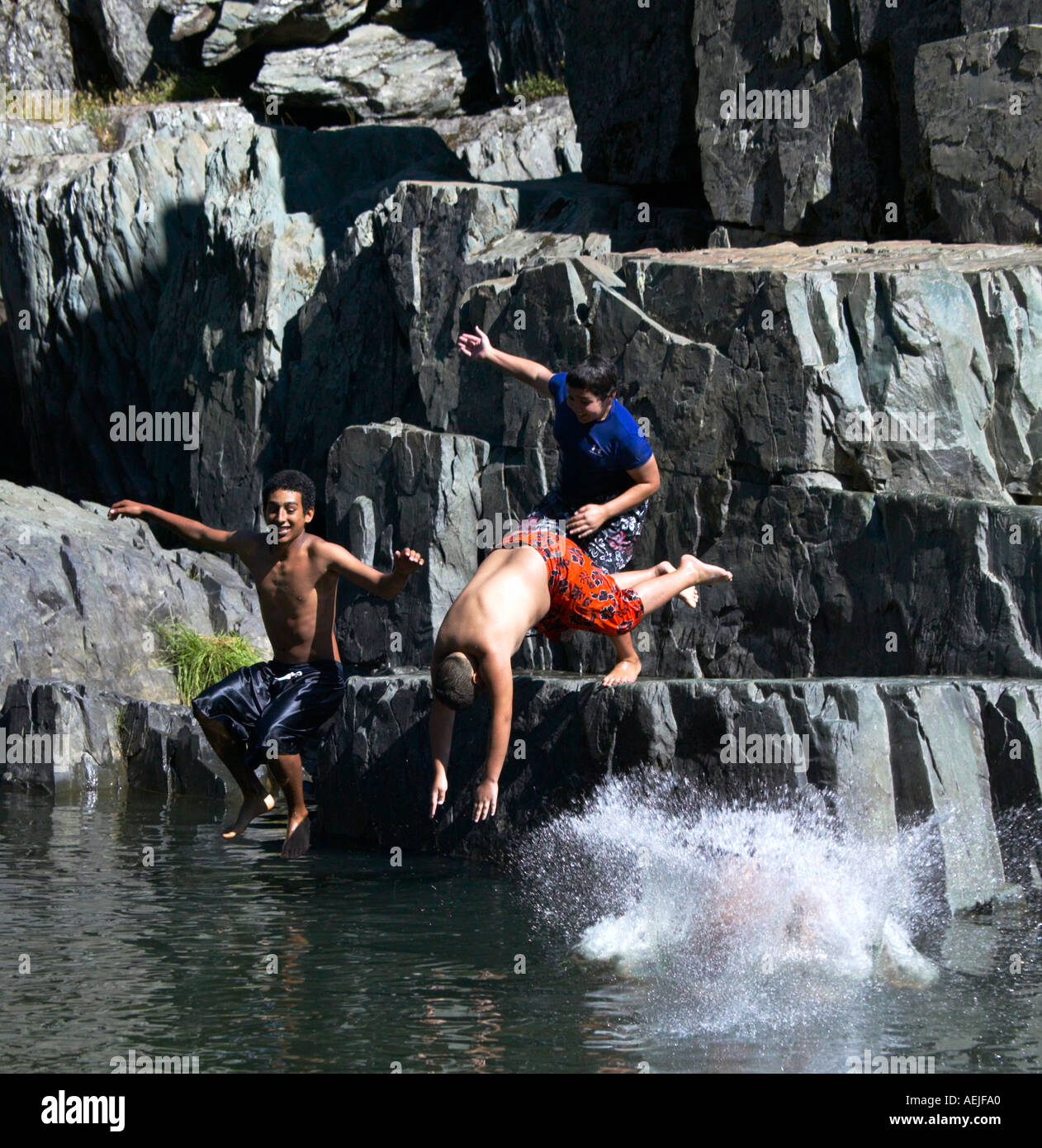 Boys diving in Spanish Creek at Indian Falls Pluams County California, multiracial group. Stock Photo