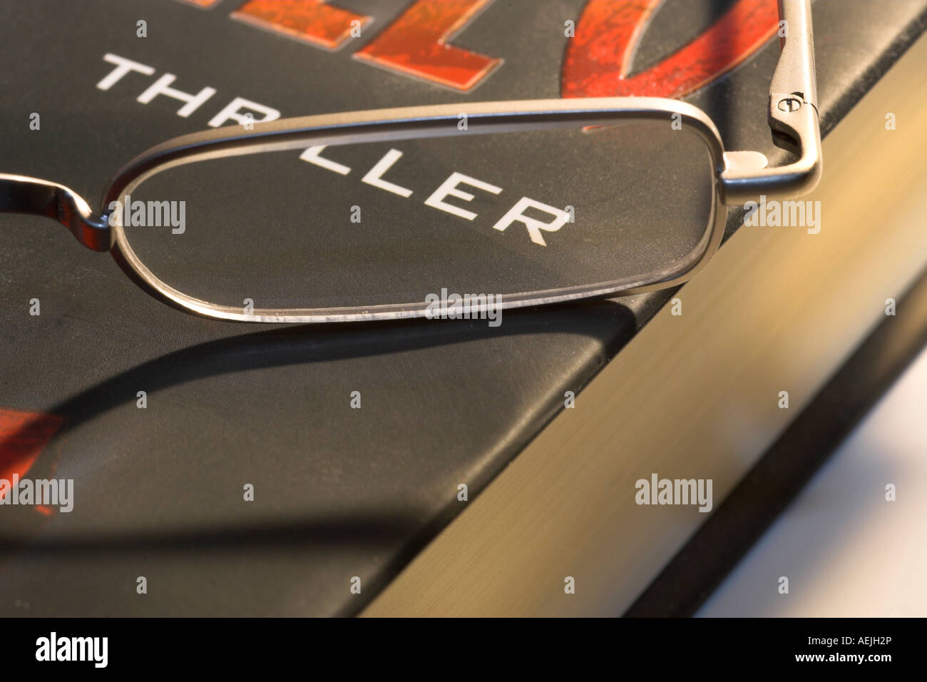 Reading glasses lying on a book Stock Photo