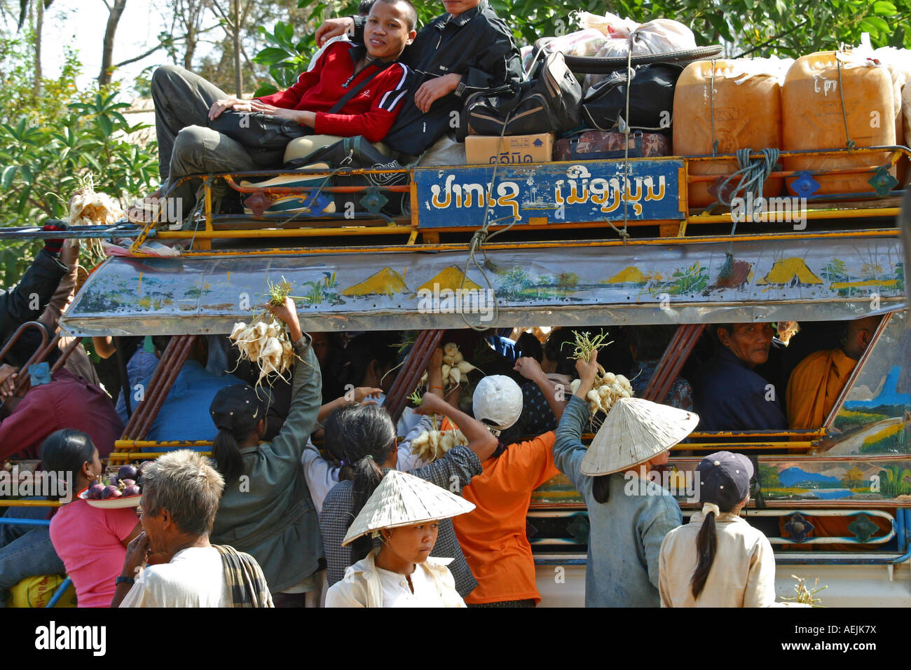 Vendors wait for customers at the busstop, Laos Stock Photo