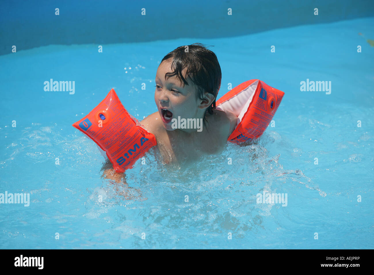 Young child with water wings in a pool Stock Photo Alamy