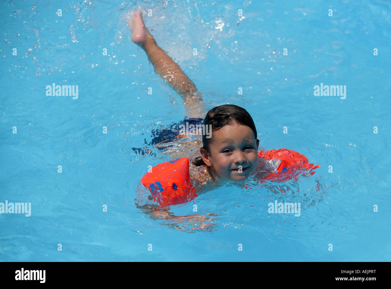 Young child with water wings in a pool Stock Photo Alamy