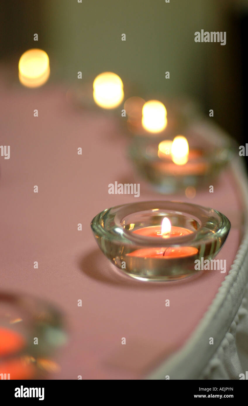 Pink tea light candles on the edge of a round table Stock Photo Alamy