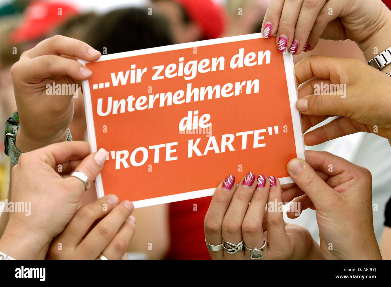 Hands on sign: " ...we show the entrepreneurs the red card". Stock Photo