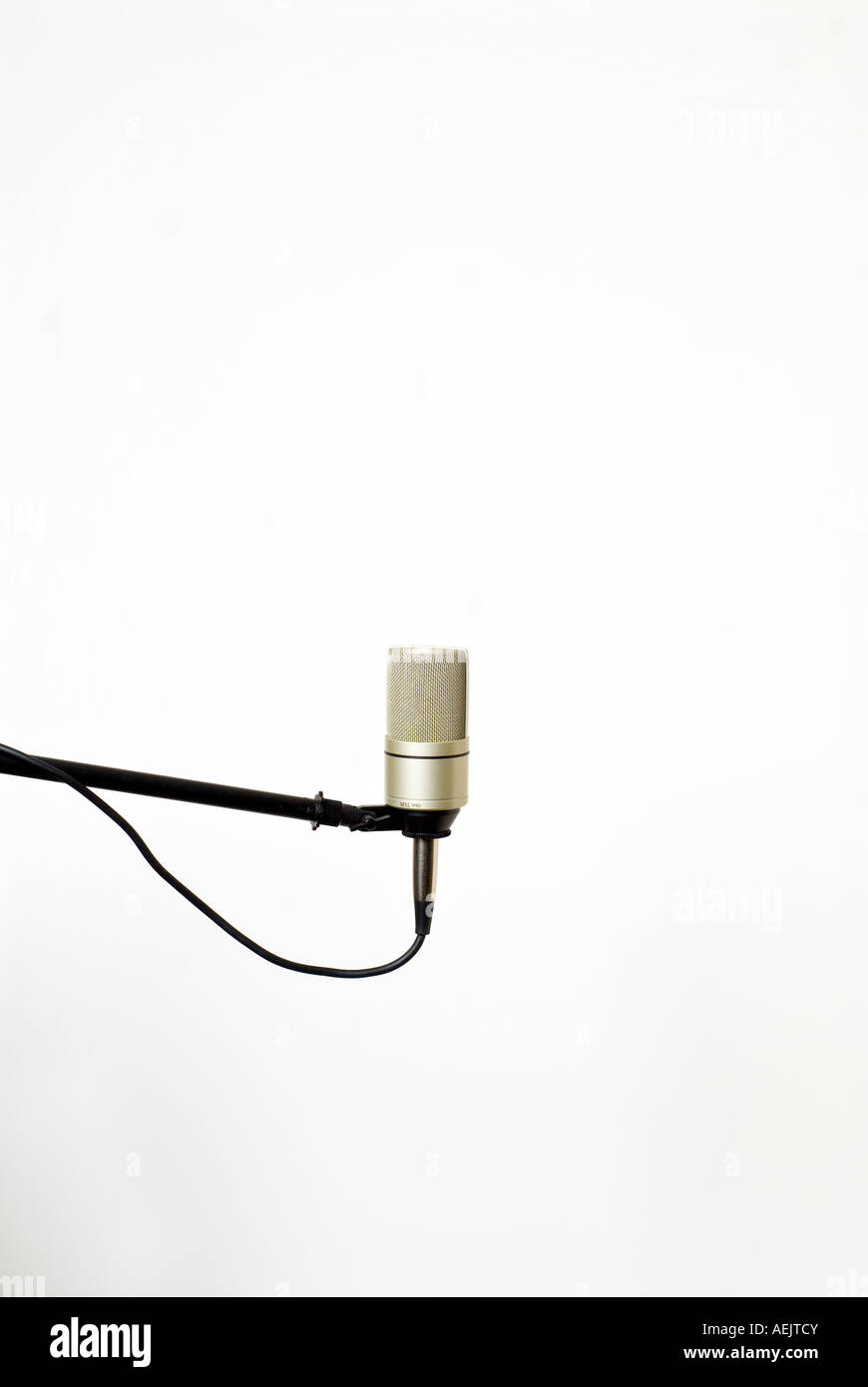 Condenser microphone on a mic stand in front of a white background Stock Photo