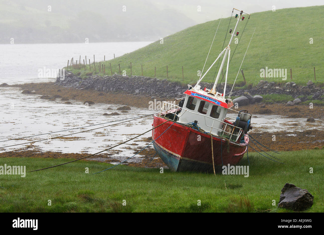 Old ship in the rain, tied up at the Atlantic coast Stock Photo
