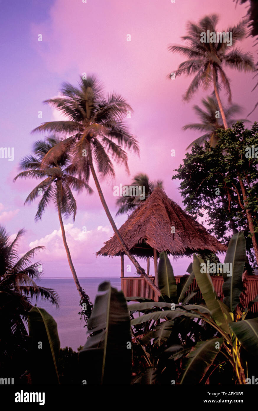 The Village Hotel thatch roofed gazebo and view from bar at dusk Pohnpei Micronesia Stock Photo