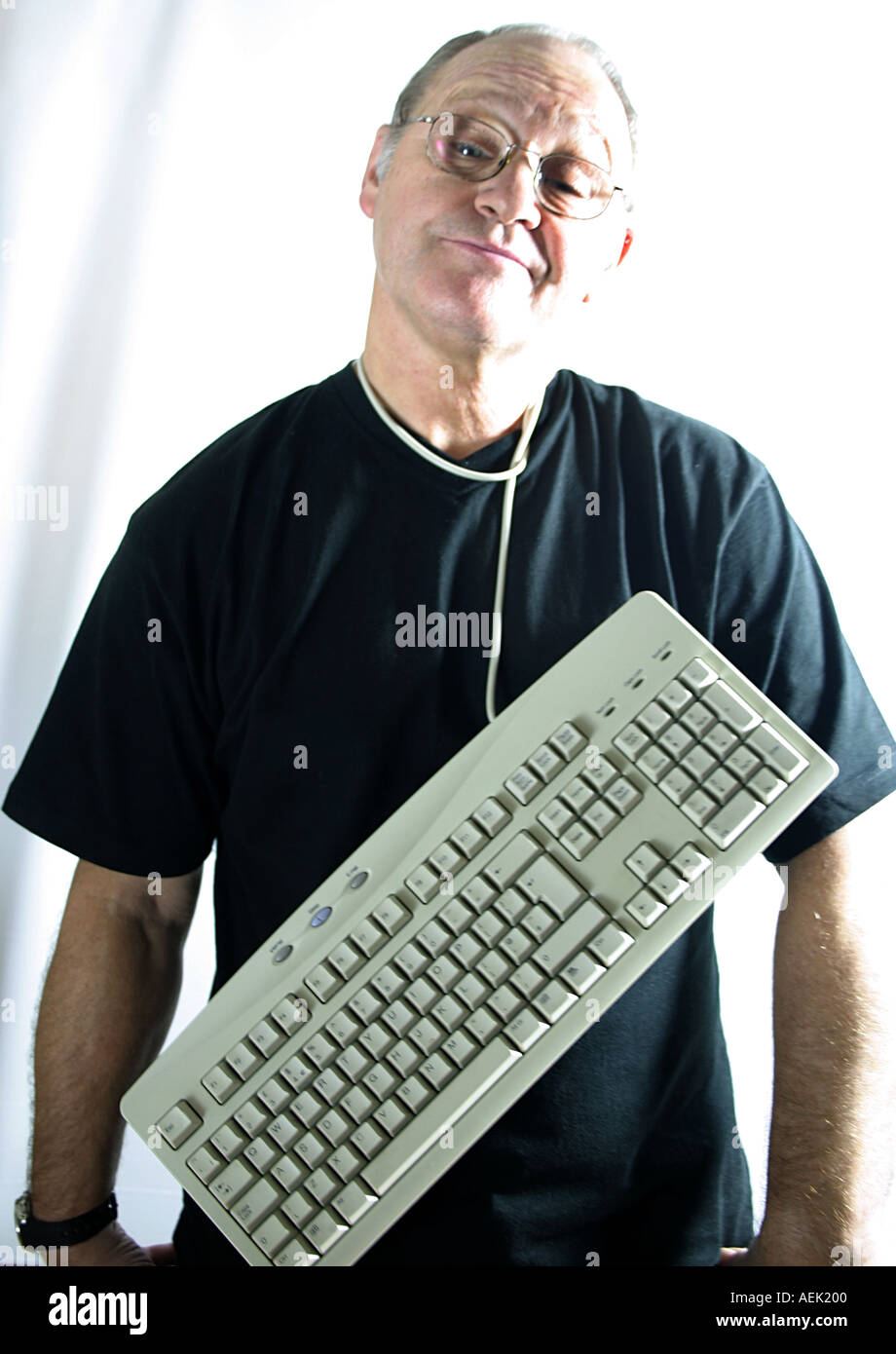 Man aged sixty with keyboard around his neck Stock Photo Alamy