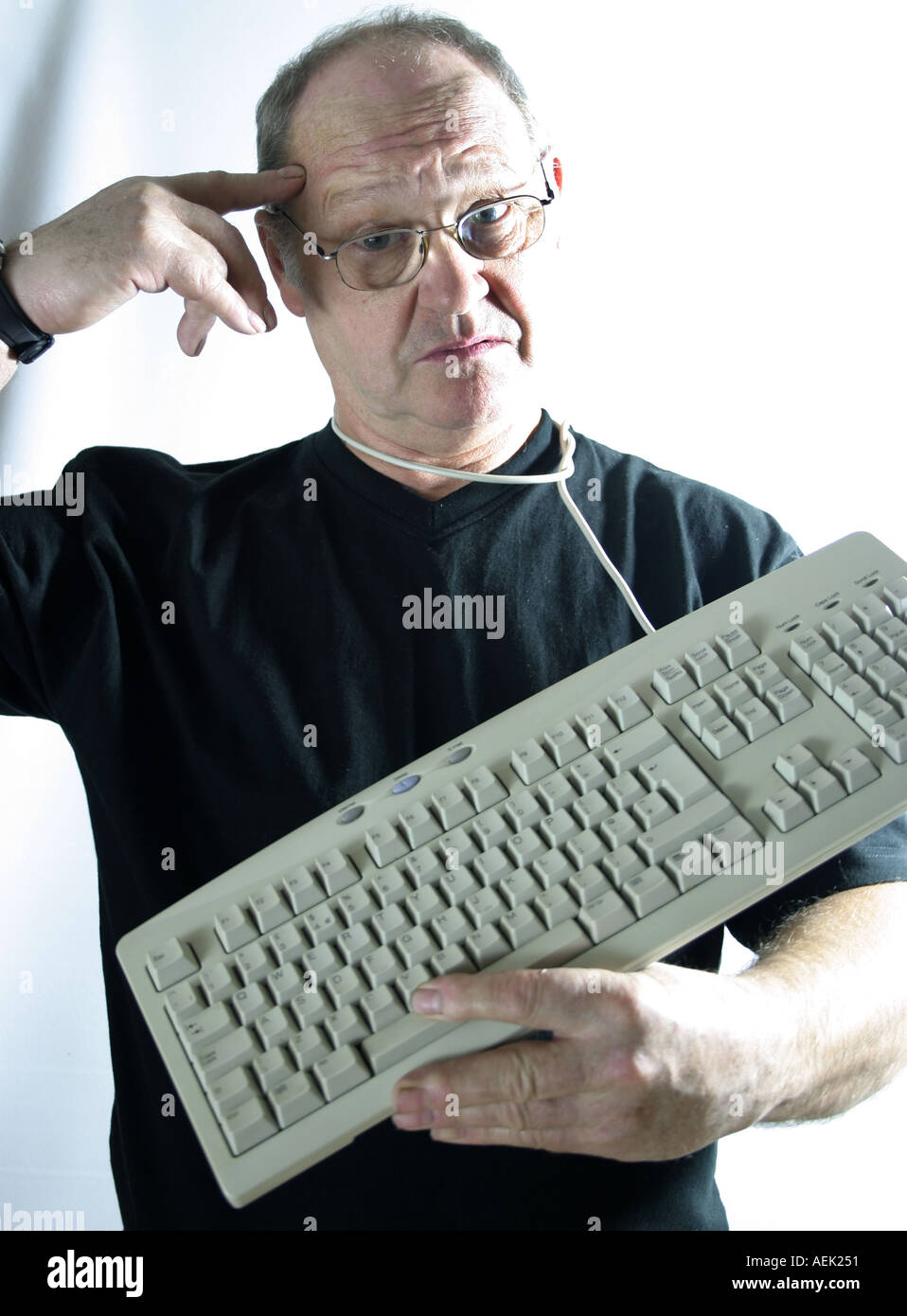 Man looking dumbfounded with keyboard around his neck Stock Photo Alamy