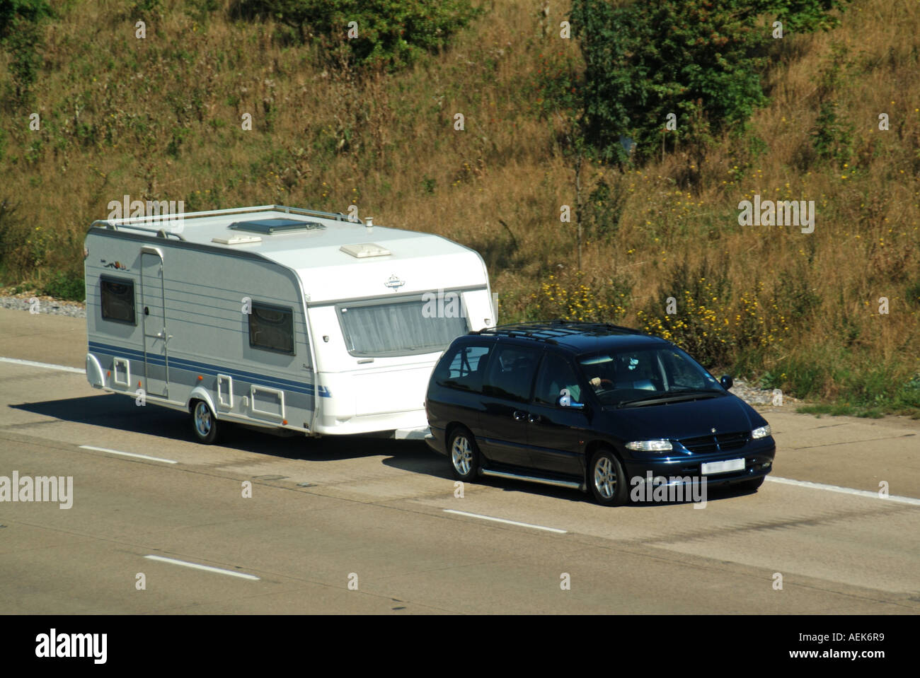 Side & front view from above of family car towing a white holiday caravan  on motorway England UK Stock Photo - Alamy