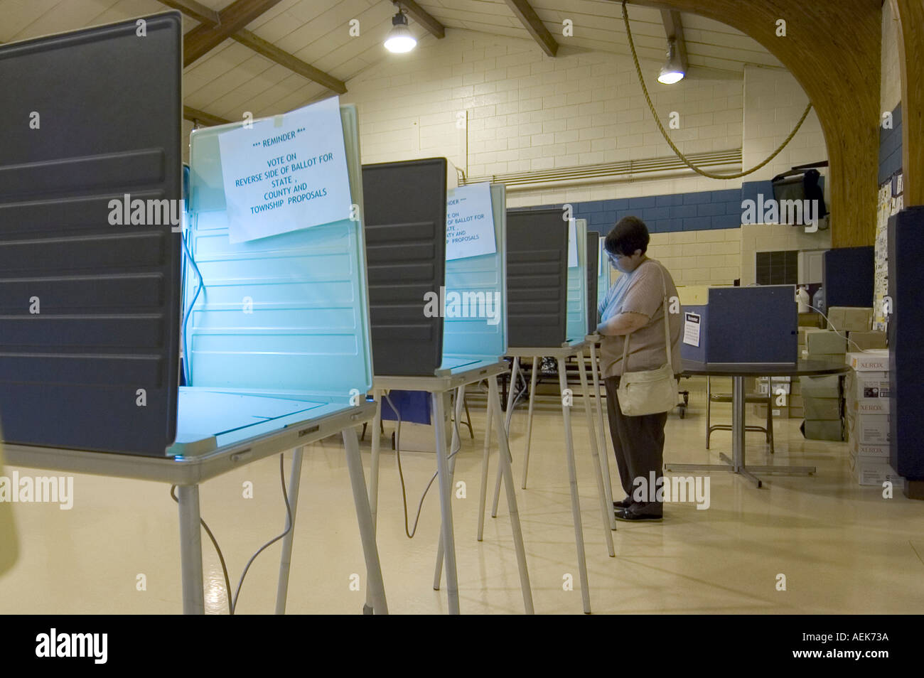 Adult female votes at an assigned precinct on election day Stock Photo