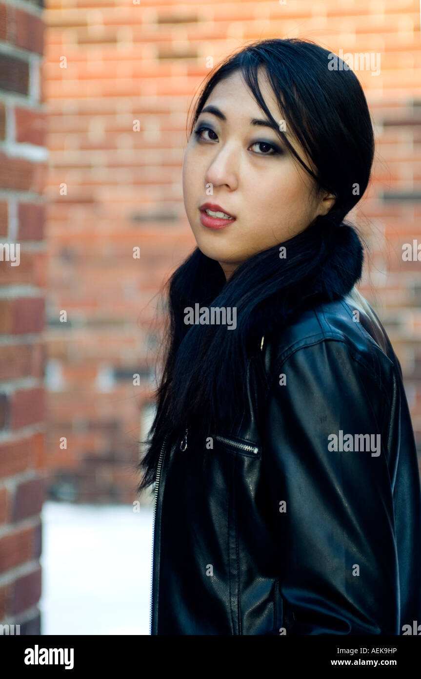Outdoor portrait of a young Asian woman outdoors in winter Stock Photo ...