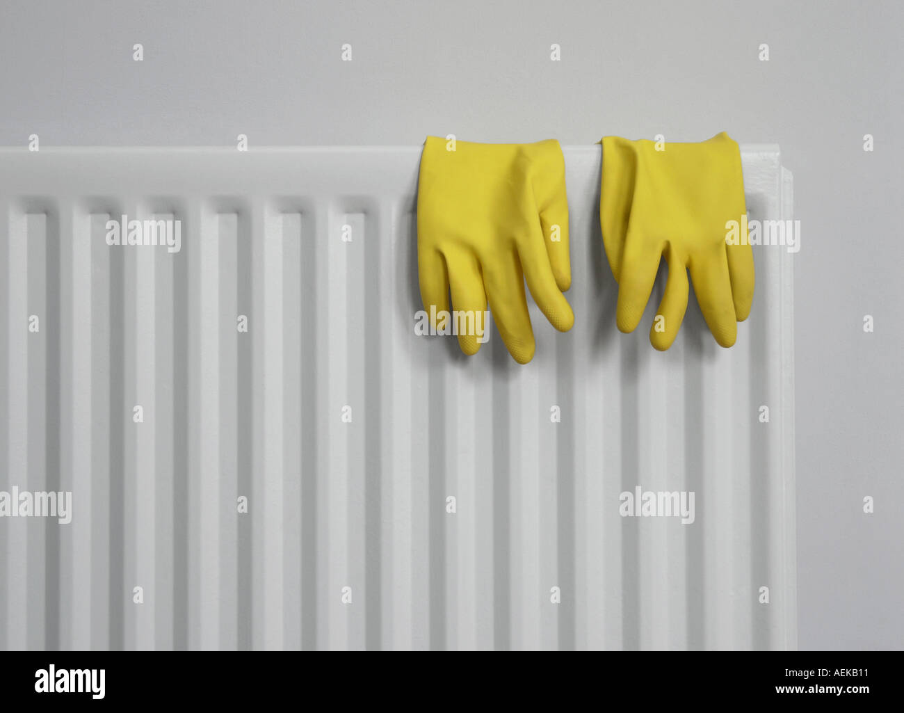 Yellow rubber gloves on grey radiator Stock Photo