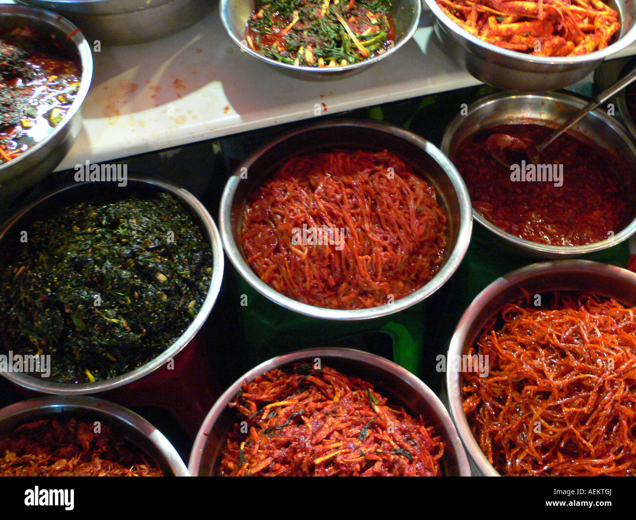 KOREA South Seoul Namdaemun market stainless steel bowls full of kimchi