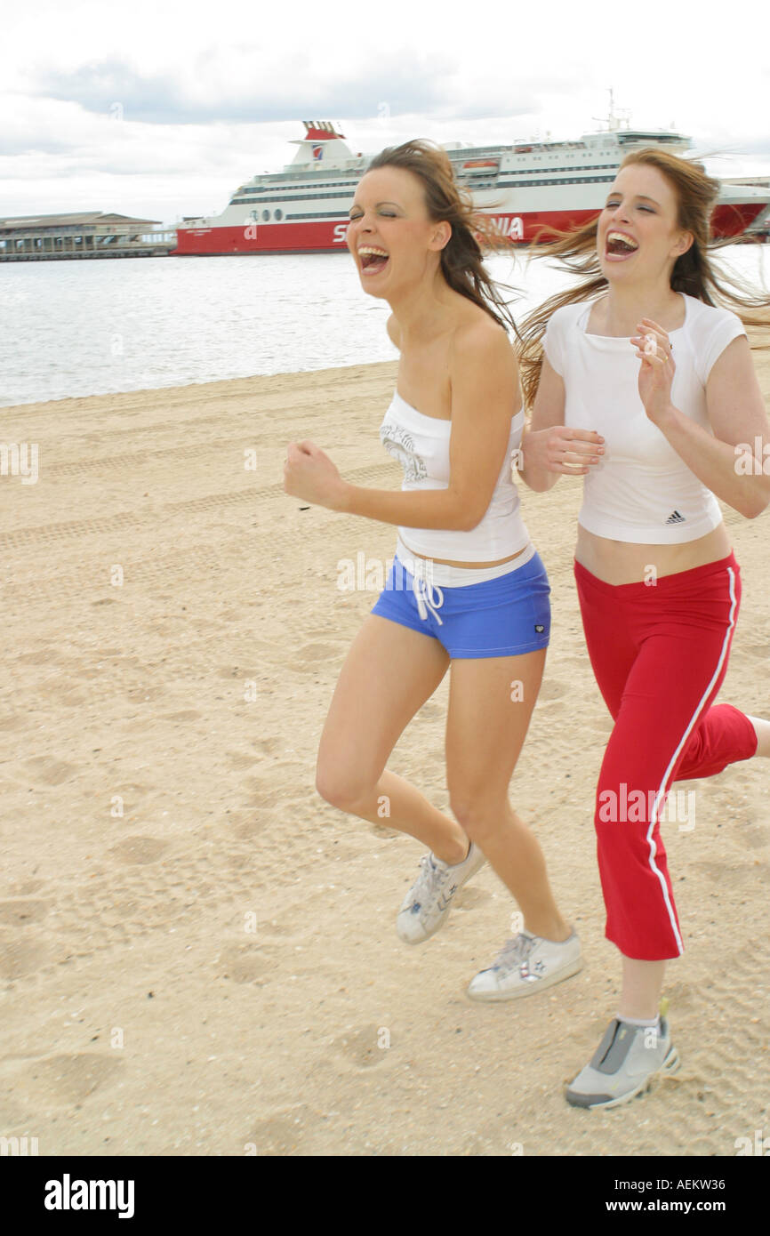 women running on beach Stock Photo