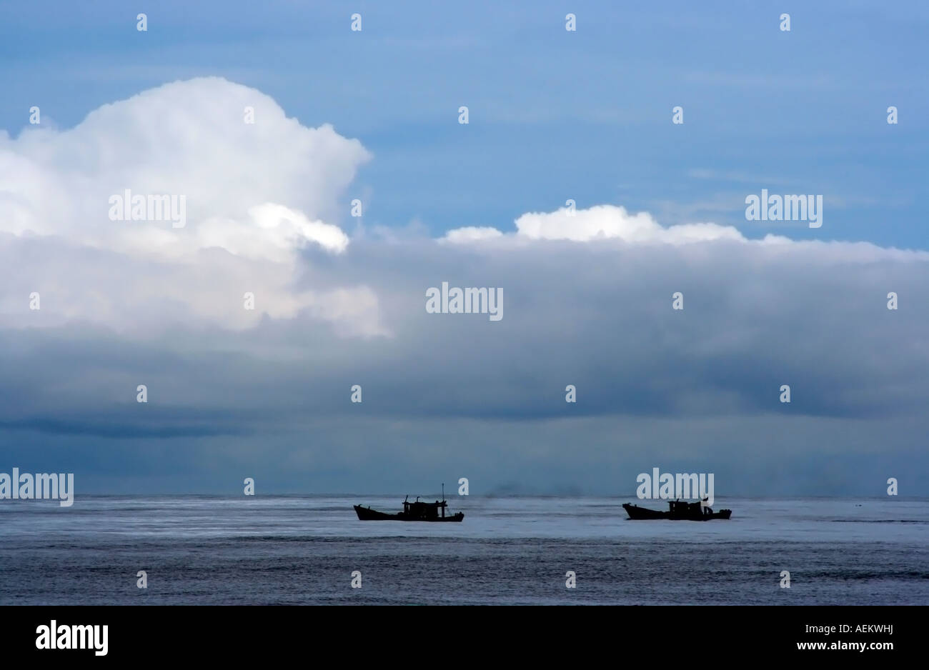 Two fishing boats with approaching storm. Stock Photo