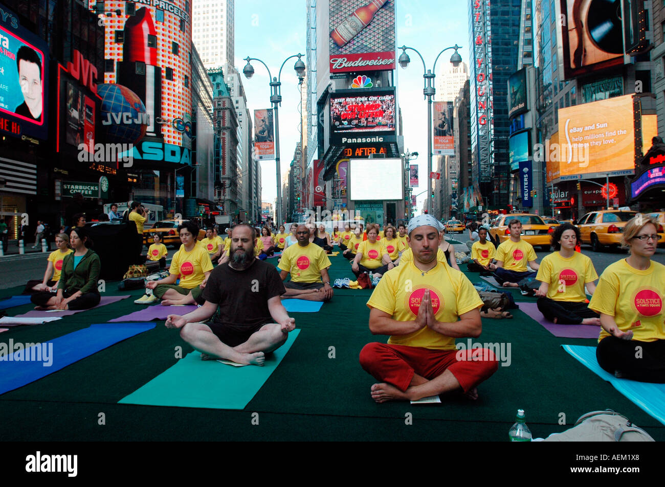 Yoga practitioners in Times Square observe the Summer Solstice Stock
