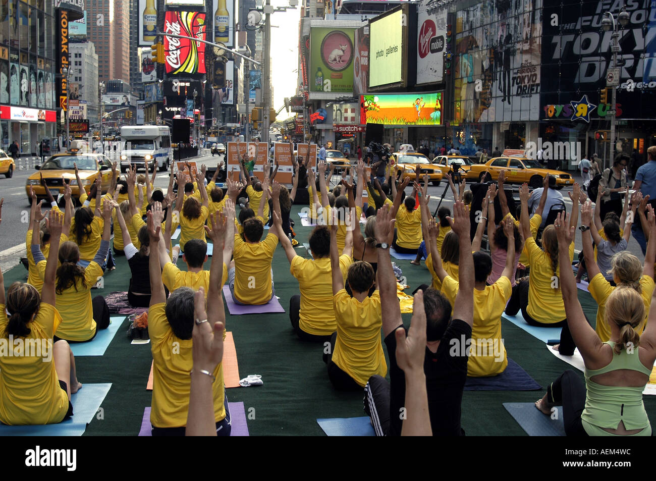 Yoga practitioners in Times Square observe the Summer Solstice Stock