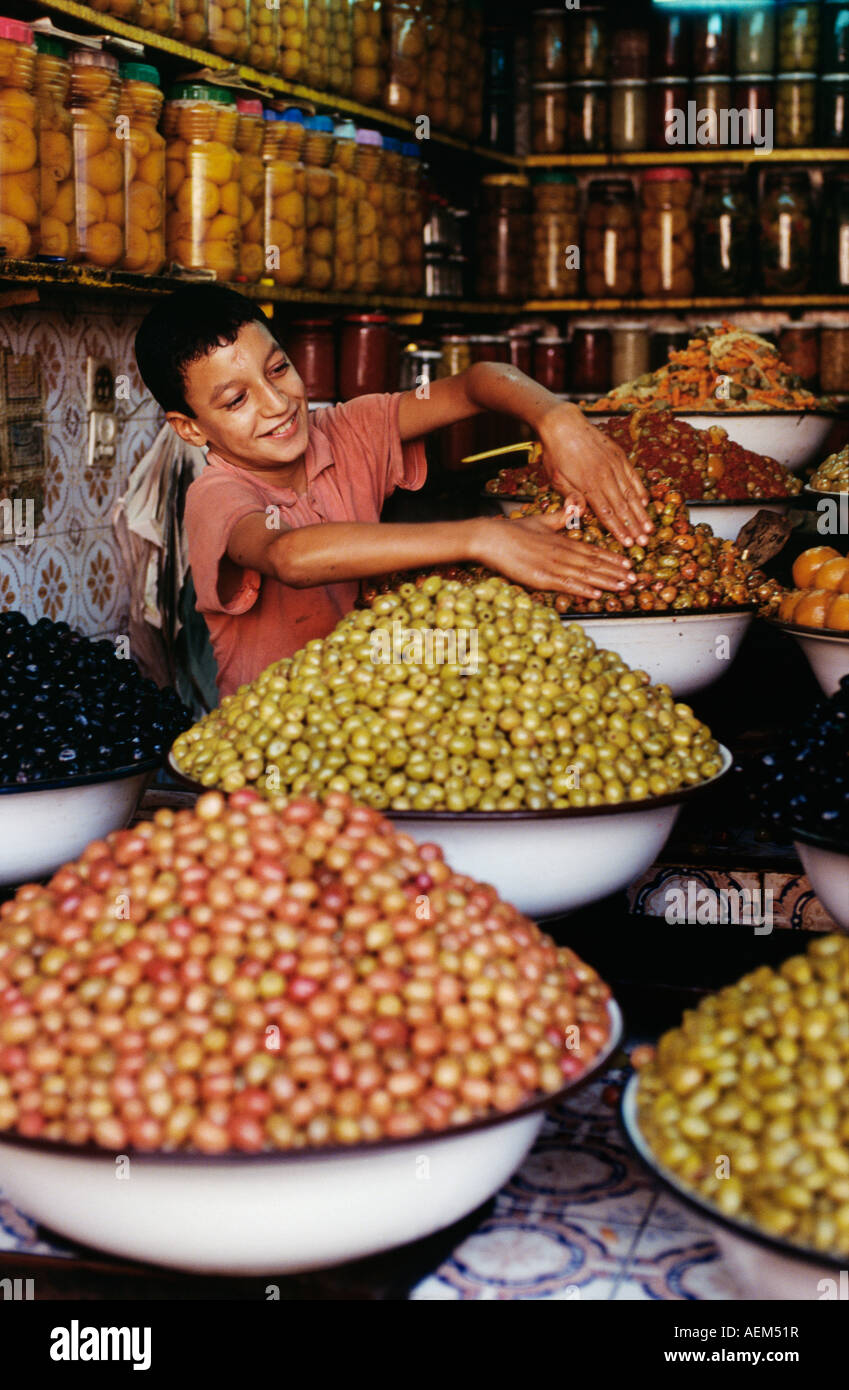 Morocco Rabat Boy selling olives at shop Stock Photo Alamy