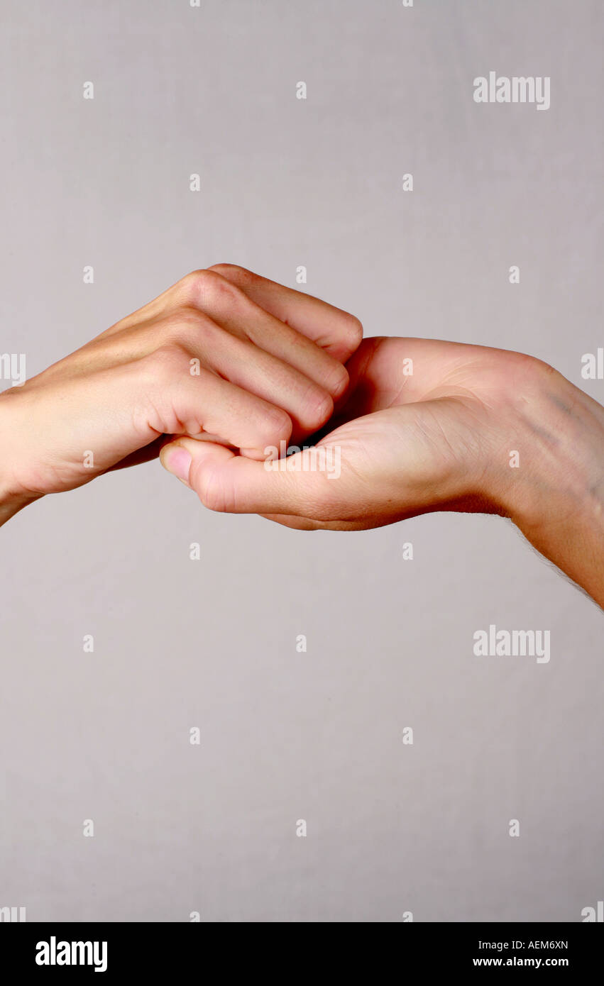 Female hands held upwards fingers interlocked together illustrating