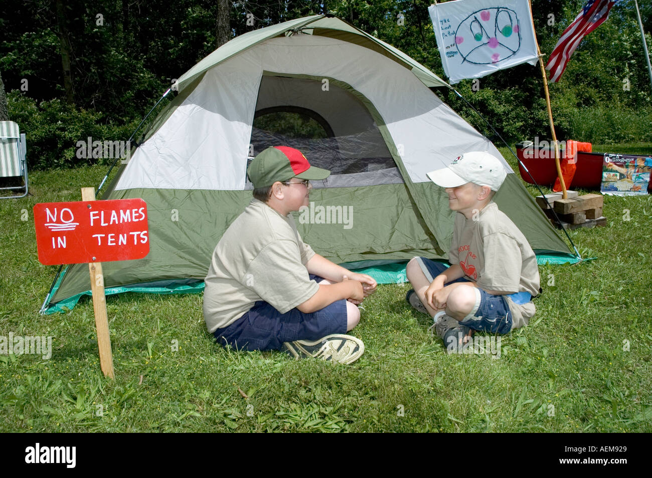Two 2 boy scouts sit in front of their tent while camping out Stock Photo Alamy