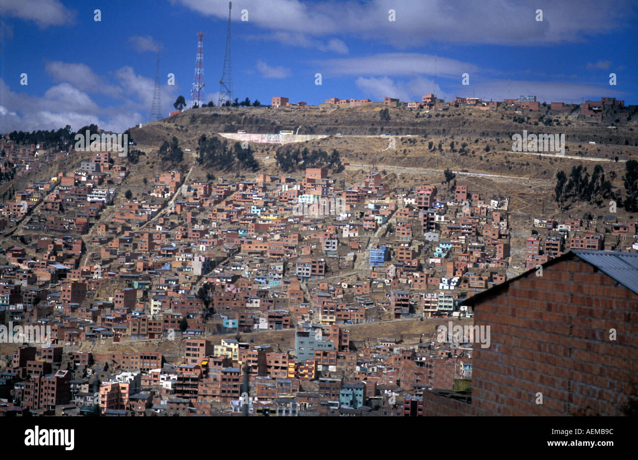Suburbs of La Paz extend to the lower slopes of surrounding mountains Abodes of simple construction hug the hillsides Bolivia Stock Photo