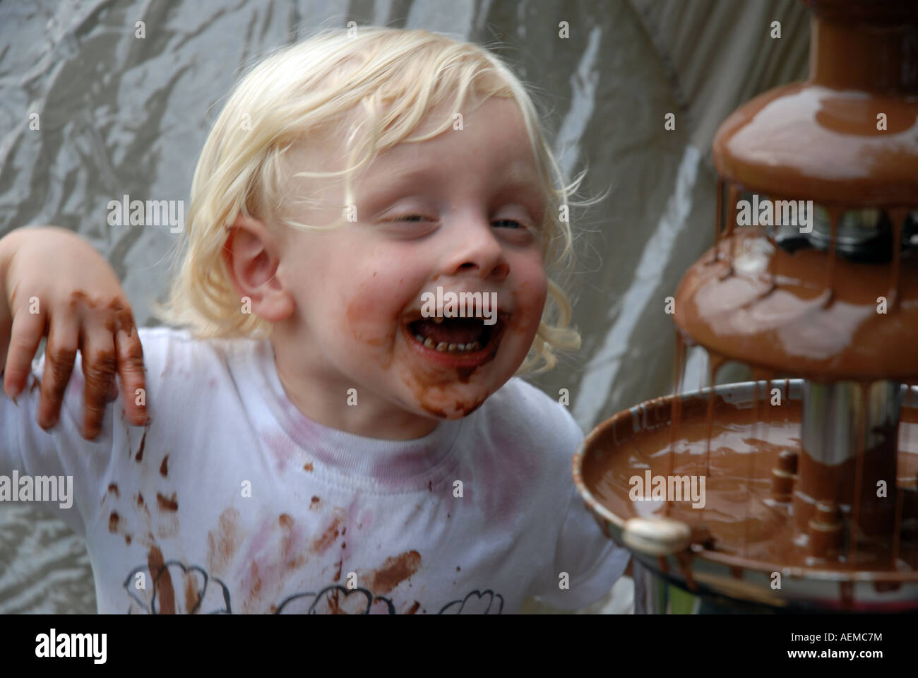 Wilf looking in delight at a chocolate fountain Stock Photo