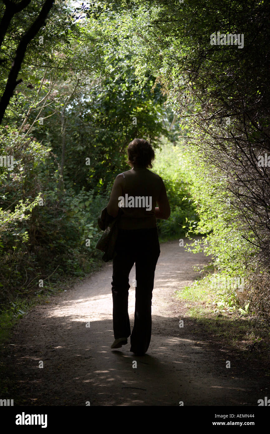 Woman walking on country lane hi-res stock photography and images - Alamy