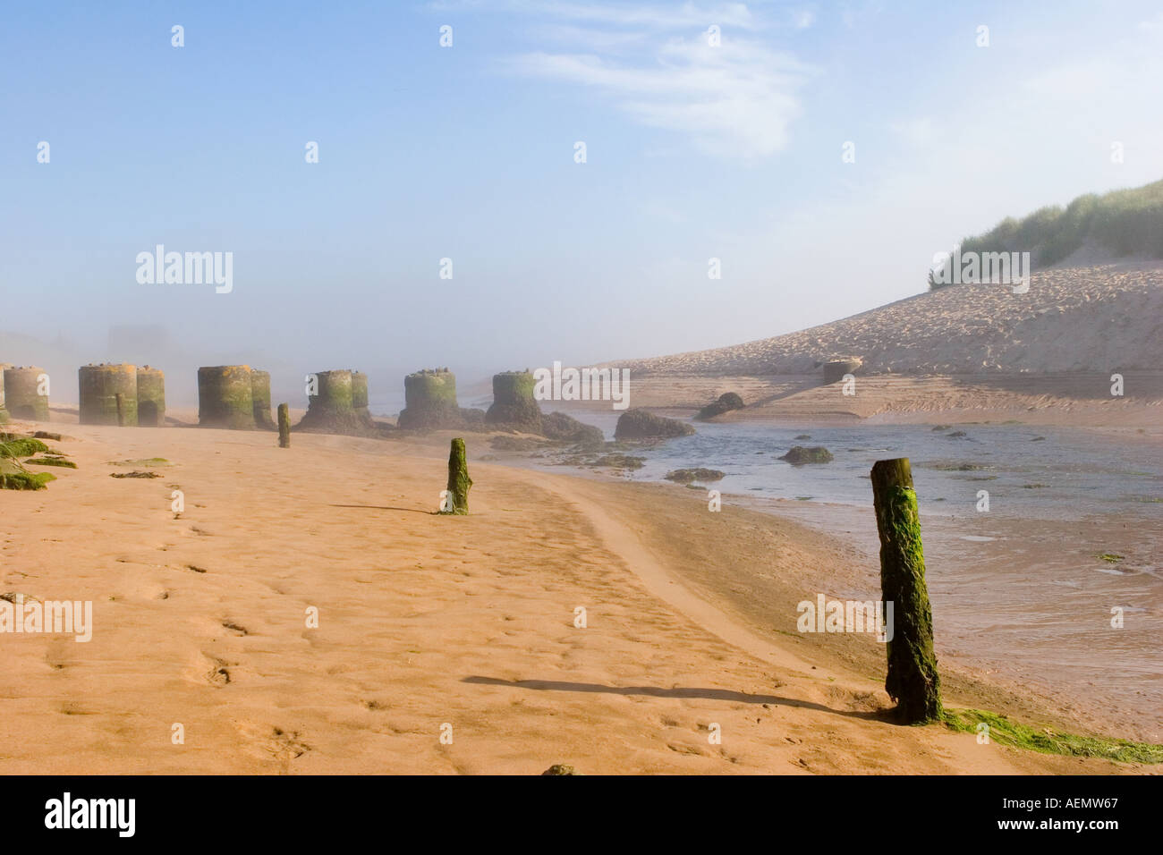 Sandy beach river estuary and Scottish coastal sea defences of several round concrete bastions at Port Errol, Cruden Bay, Scotland, Aberdeenshire UK Stock Photo