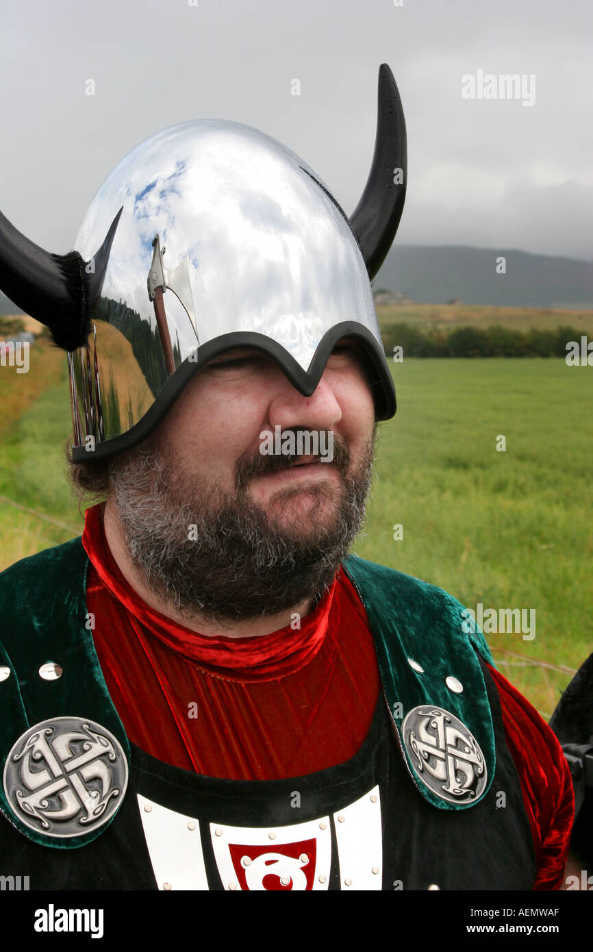 Viking Norse men Shetland marchers Tarland Highland Games stainless steel helmets axes roar entertainers man outside daylight Stock Photo
