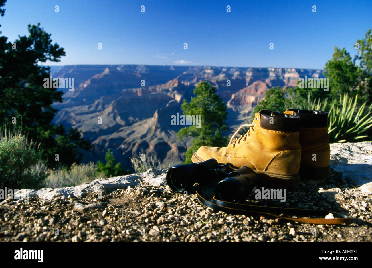 hiking boots with binocular at the edge of grand canyon south rim