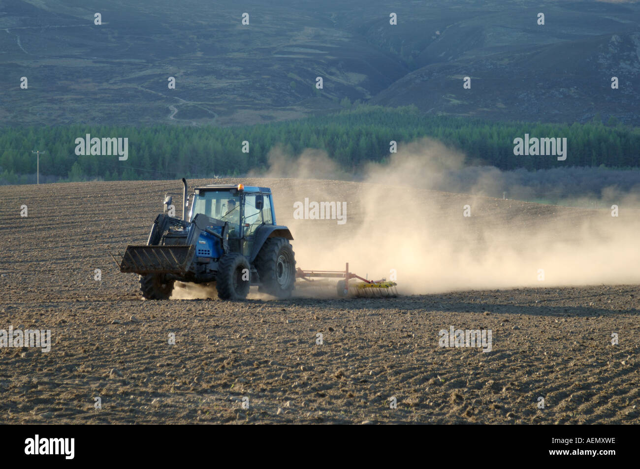 Farm Field Management in dry Spring weather.   XAG-814 Stock Photo
