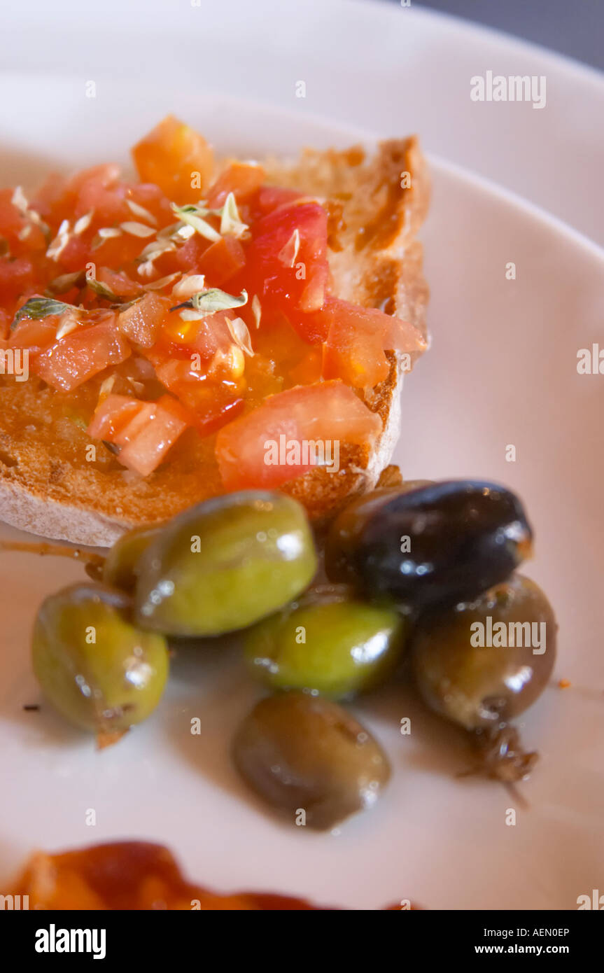 In the restaurant. Tomato on bread. Olives. Herdade da Malhadinha Nova