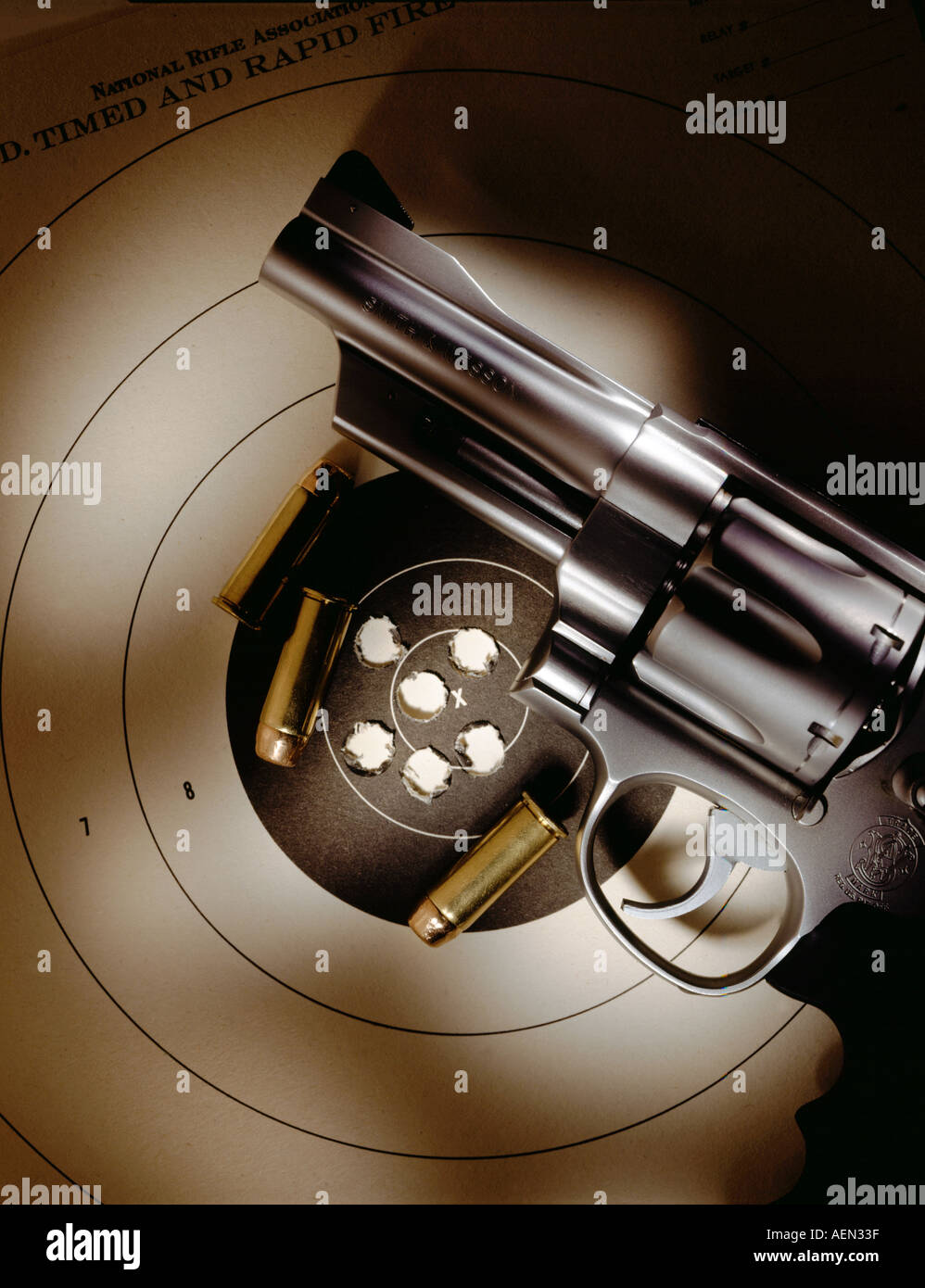 handgun pistol on target with bullets used in target practice Stock