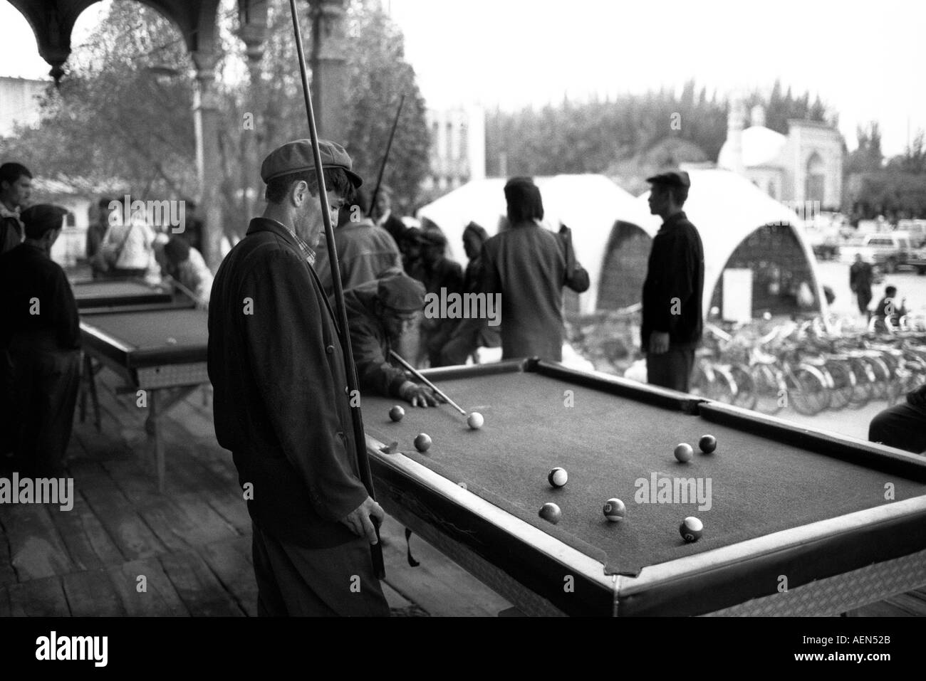 Unemployed Uygurs spend their time playing pool in the town of Kashgar, Xinjiang Province, Peoples Republic of China. Stock Photo