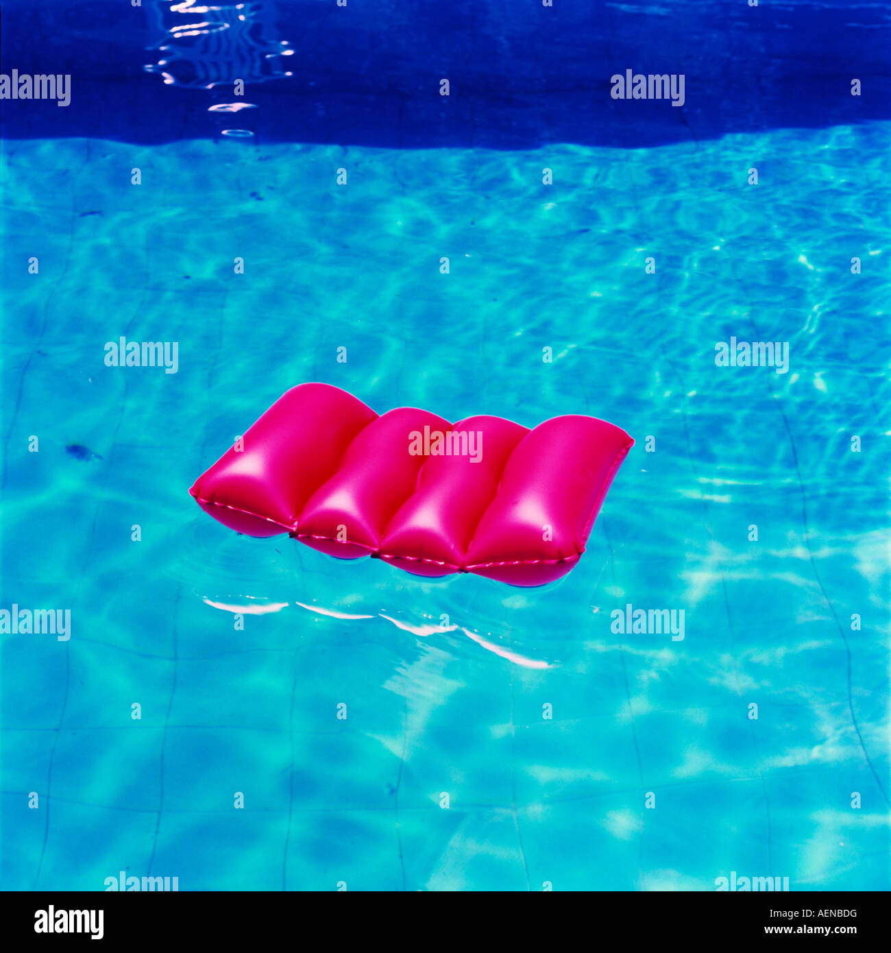 Lilo in swimming pool Stock Photo