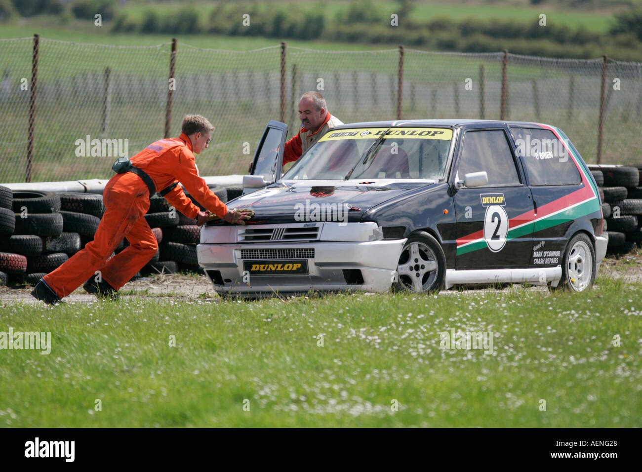 Marshall pushes crashed Fiat Uno at Kirkistown Circuit county down Northern Ireland Stock Photo
