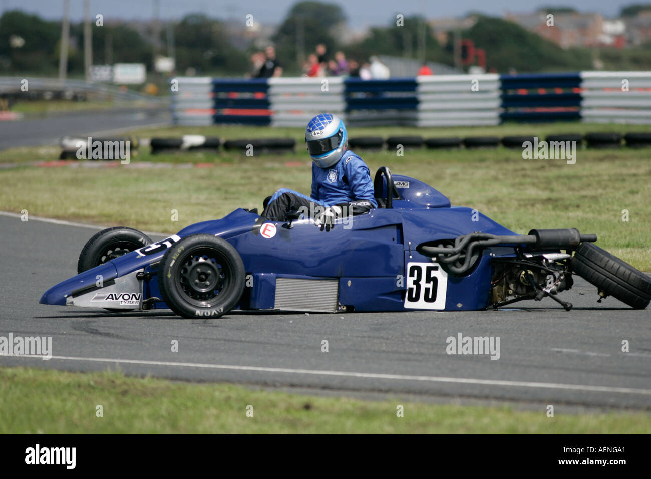Kris Loane from Kesh climbs out of his crashed blue Van Diemen RF92 Formula Ford FF 1600 at Kirkistown Circuit county down Stock Photo