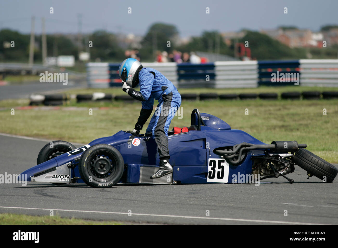 Kris Loane from Kesh climbs out of his crashed blue Van Diemen RF92 Formula  Ford FF 1600 at Kirkistown Circuit county down Stock Photo - Alamy